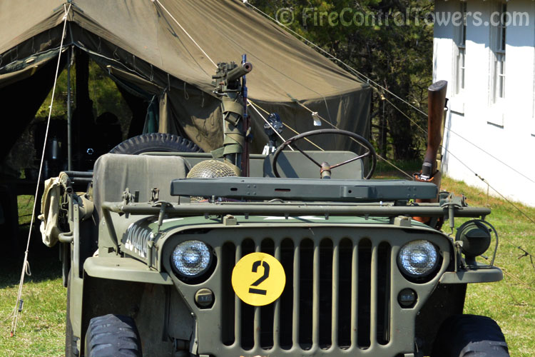 Army jeep with mounted and side-holstered machine guns